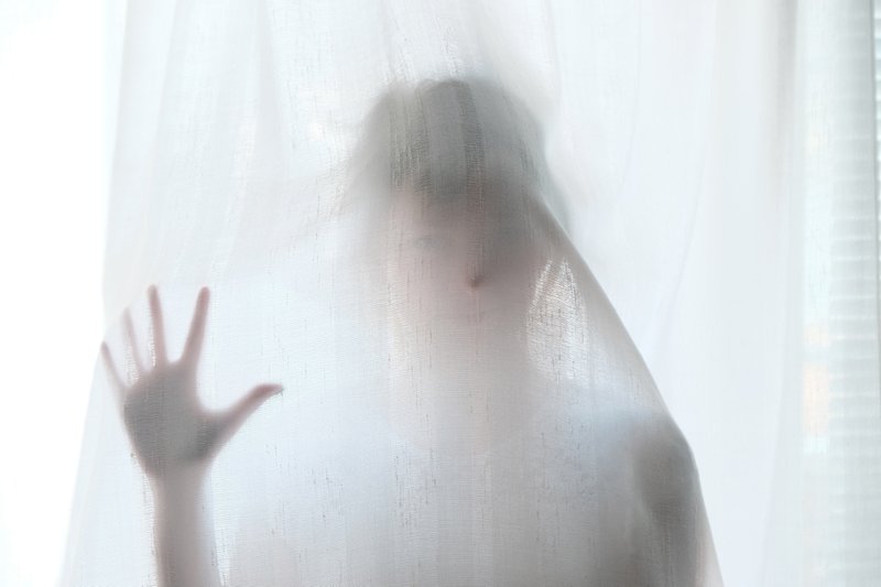 Girl touching a shower curtain
